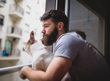 Man looks out window pensively