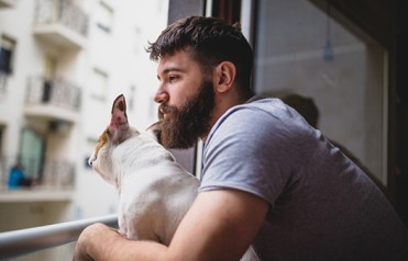 Man looks out window pensively