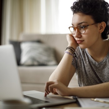 A person looks at a laptop screen.