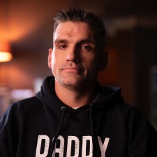 Brandon, a Metis man, wearing a sweatshirt that says "Daddy on duty."