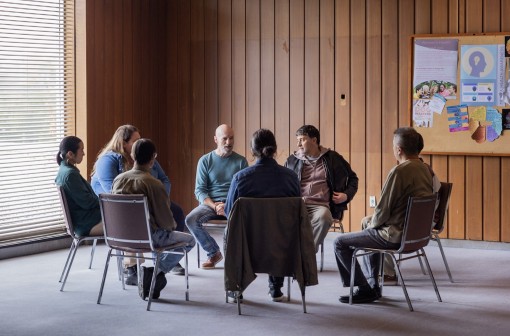 people sit in a group setting