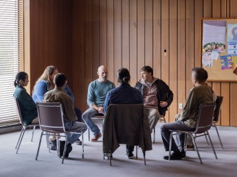 people sit in a group setting