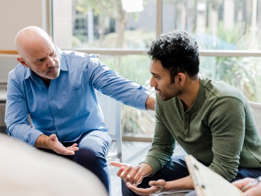 Two men talking together.